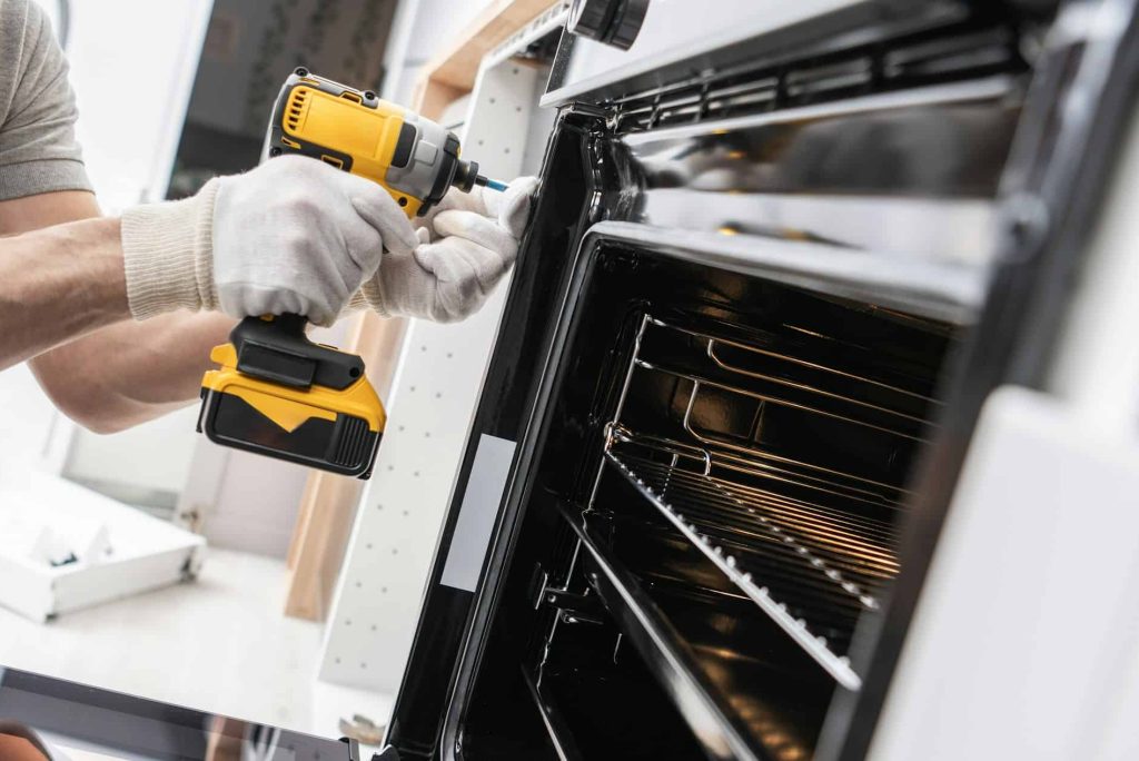 home-appliances-technician-installing-a-stove.jpg